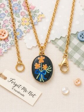 Oval Gold Necklace with Black Floral Pendant